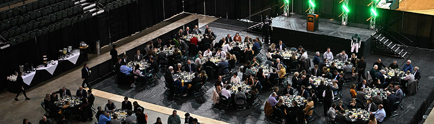 photo of the tables, stage, and attendees of the first pitch banquet on the nutter center floor